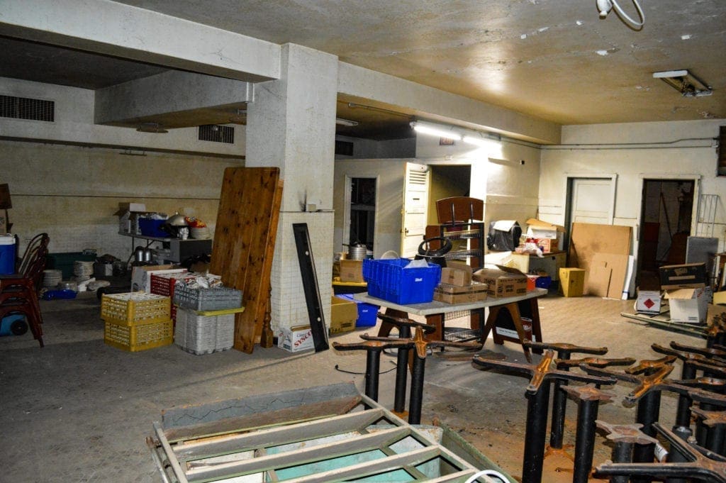 A large basement room used for storage.
