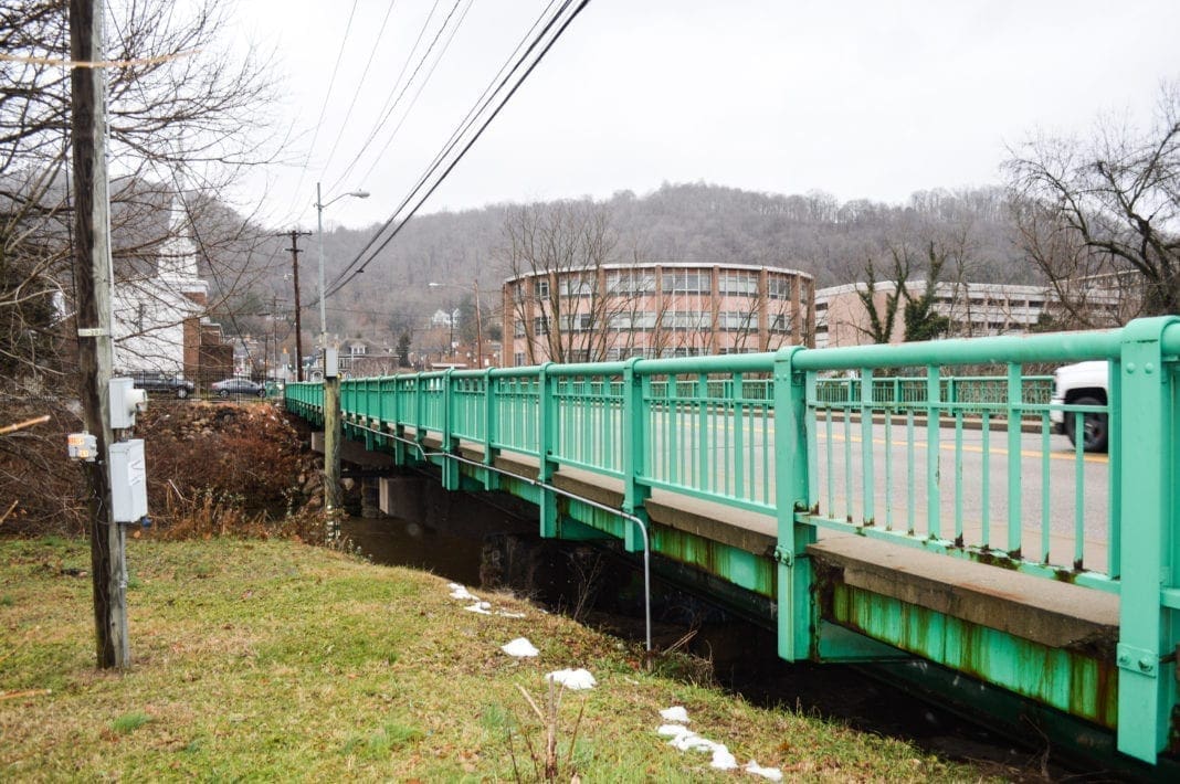 The bridge in this photo is green except where an orange rust color takes over.