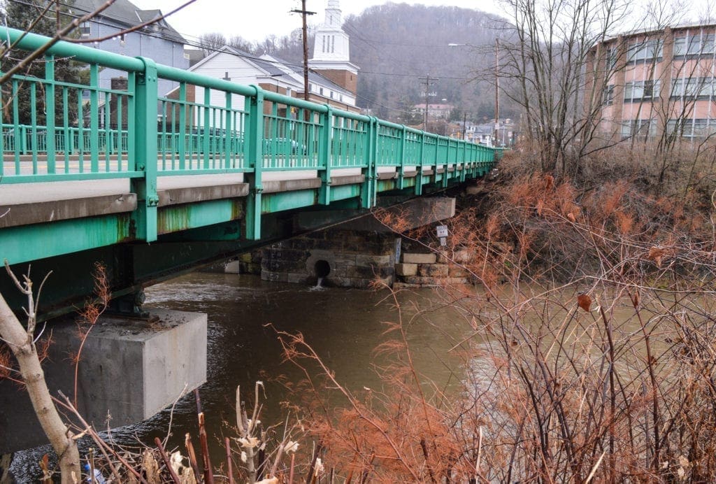 A photo of an aging, two-lane bridge.