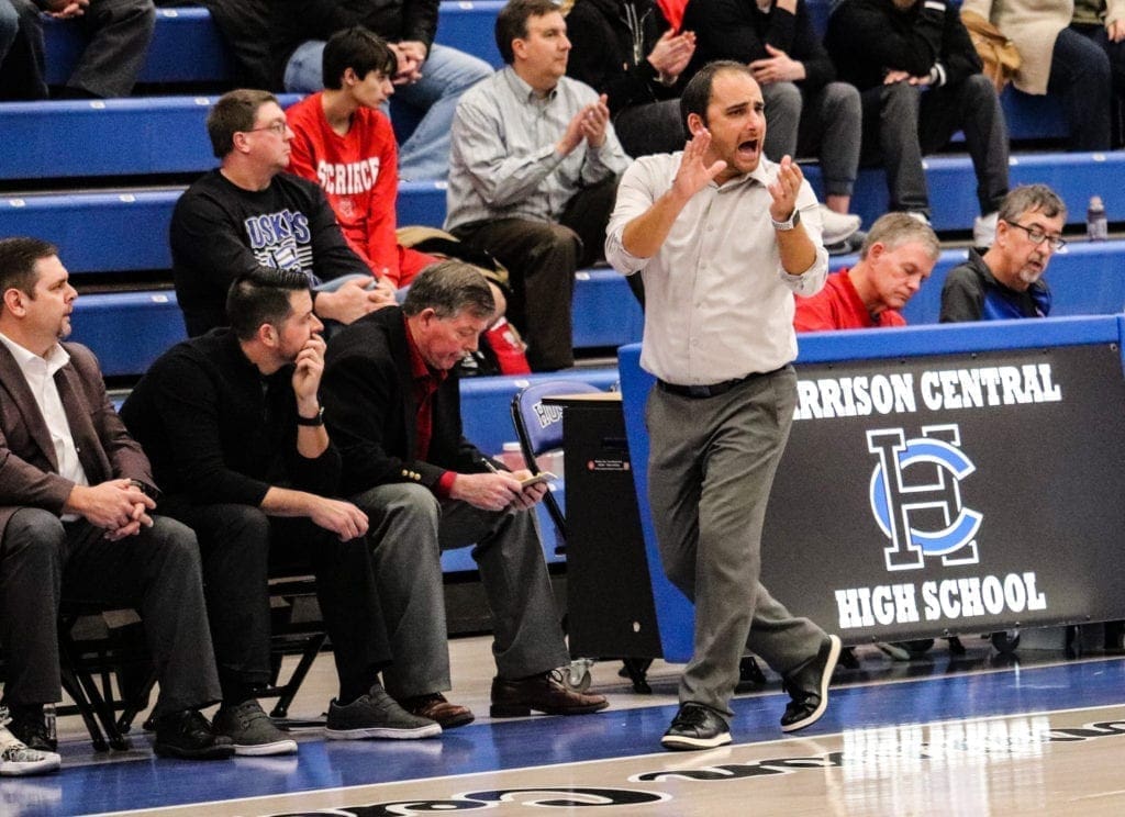 A basketball coach rooting for his squad.