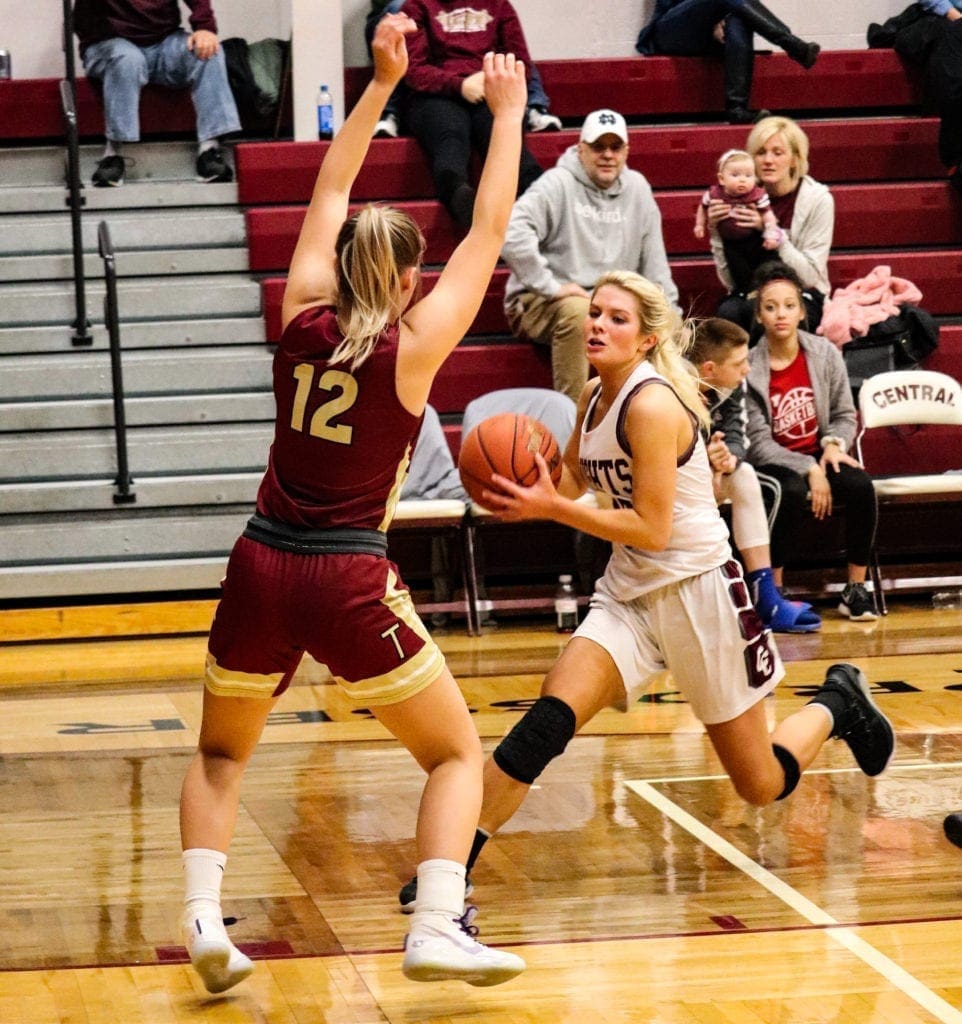 A tall player blocking the way to the hoop.