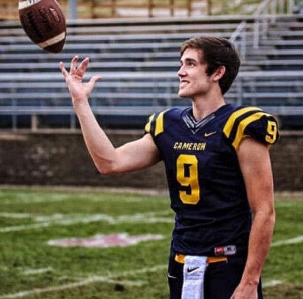A football player twirling a football.