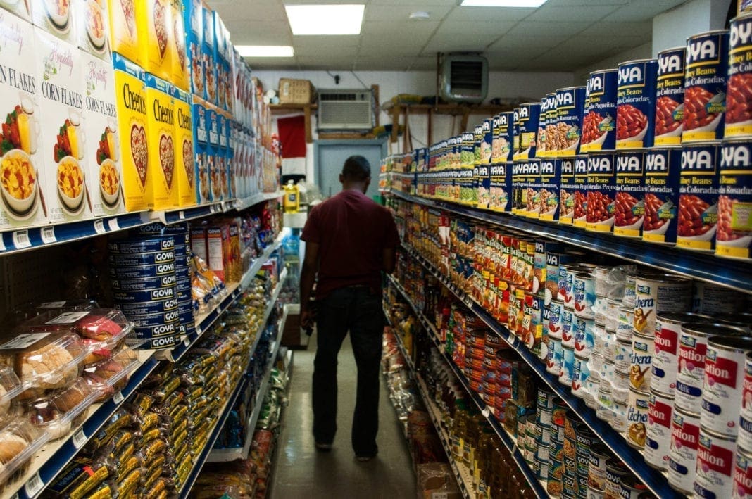 A photo of a man in a grocery store aisle.