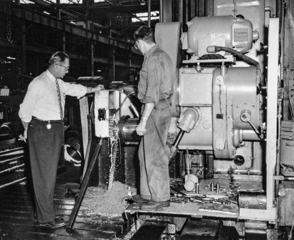 A Blaw Knox factory executive with a plant worker.