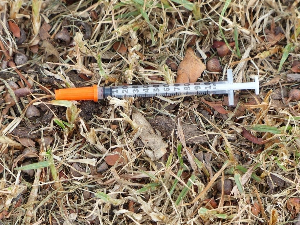 A needle on the ground.