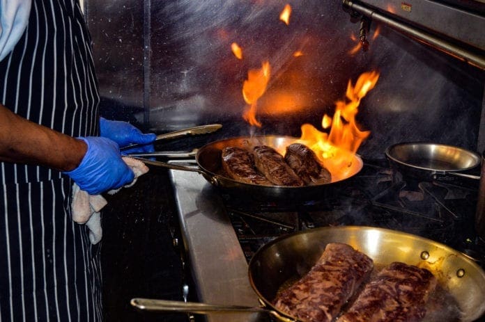 A photo of steak filets in a skillet.