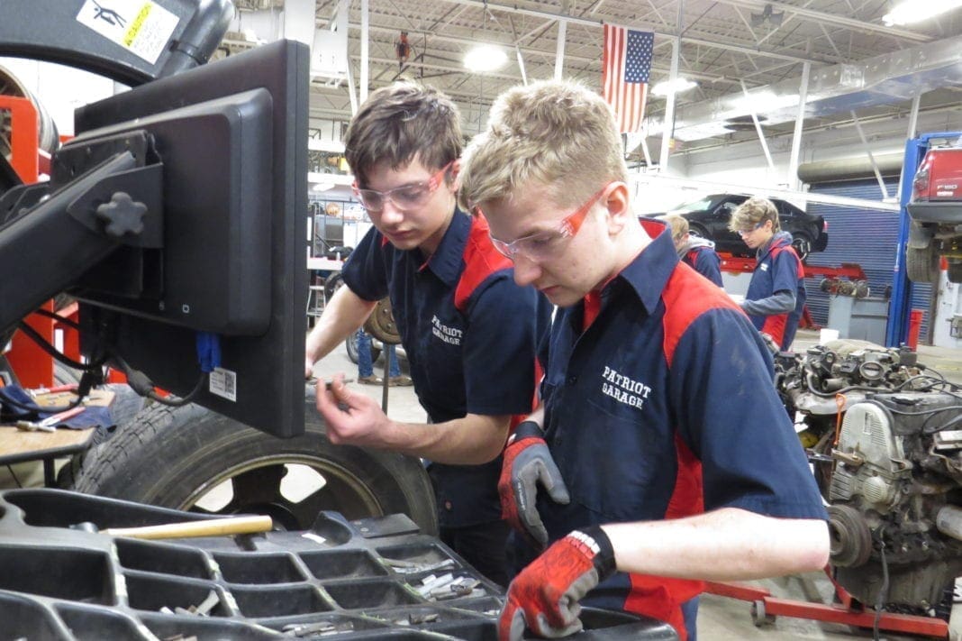 Students working on a tire.