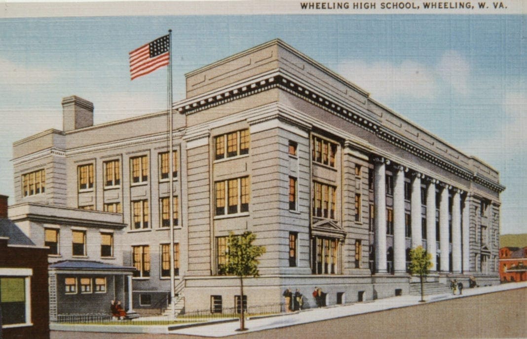 A postcard of a school building with a lot of column in front.