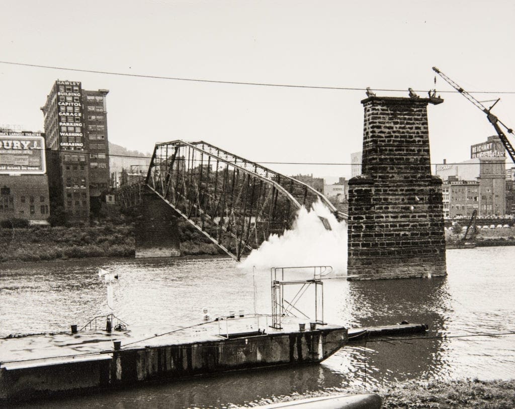 A photo of a bridge being demolished.