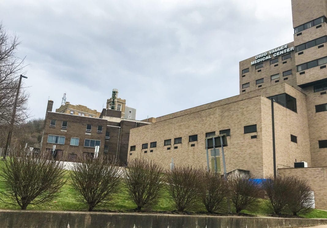 The image displays a hospital that has been expanded in different eras.