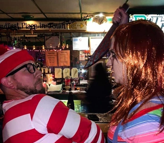 A photo of two people in Halloween costumes.