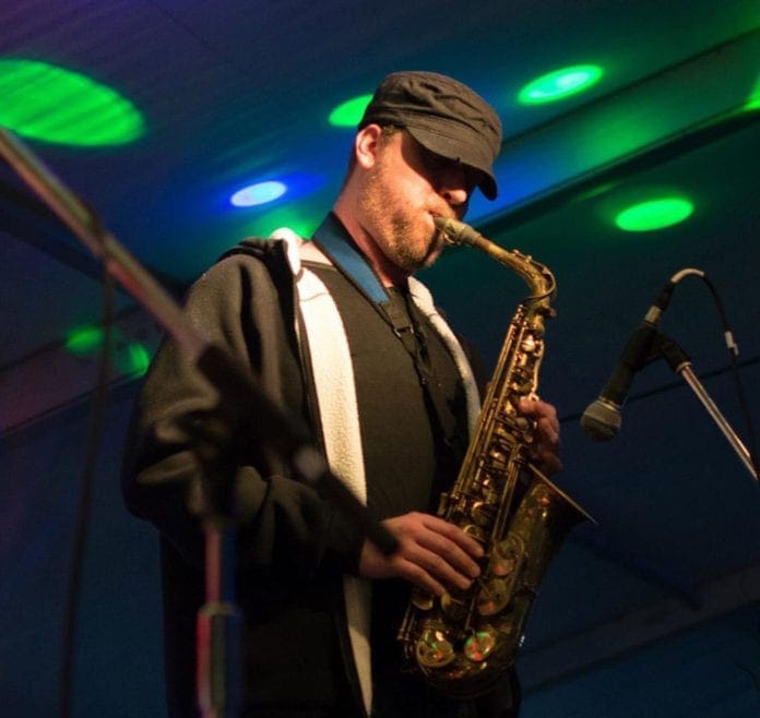A photo of a man playing the sax.