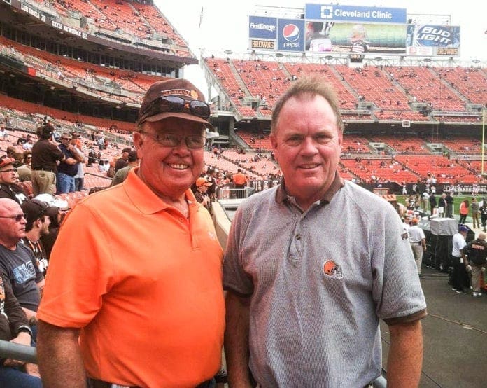 A father and son at a football game.