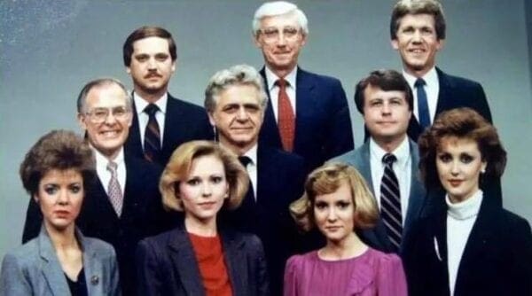 An older photo of a news team.