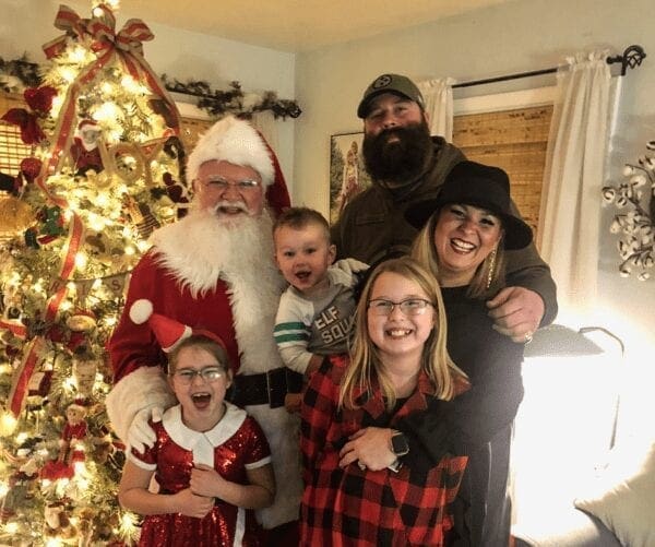 A family of five with Santa Claus.