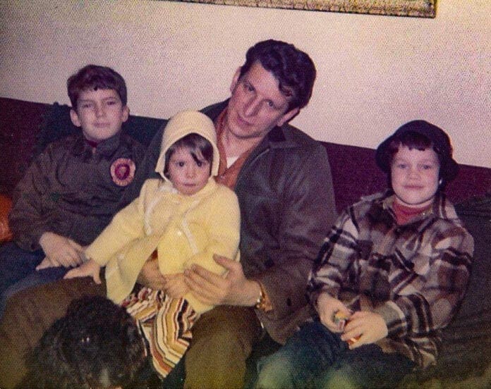 A man and his three kids.