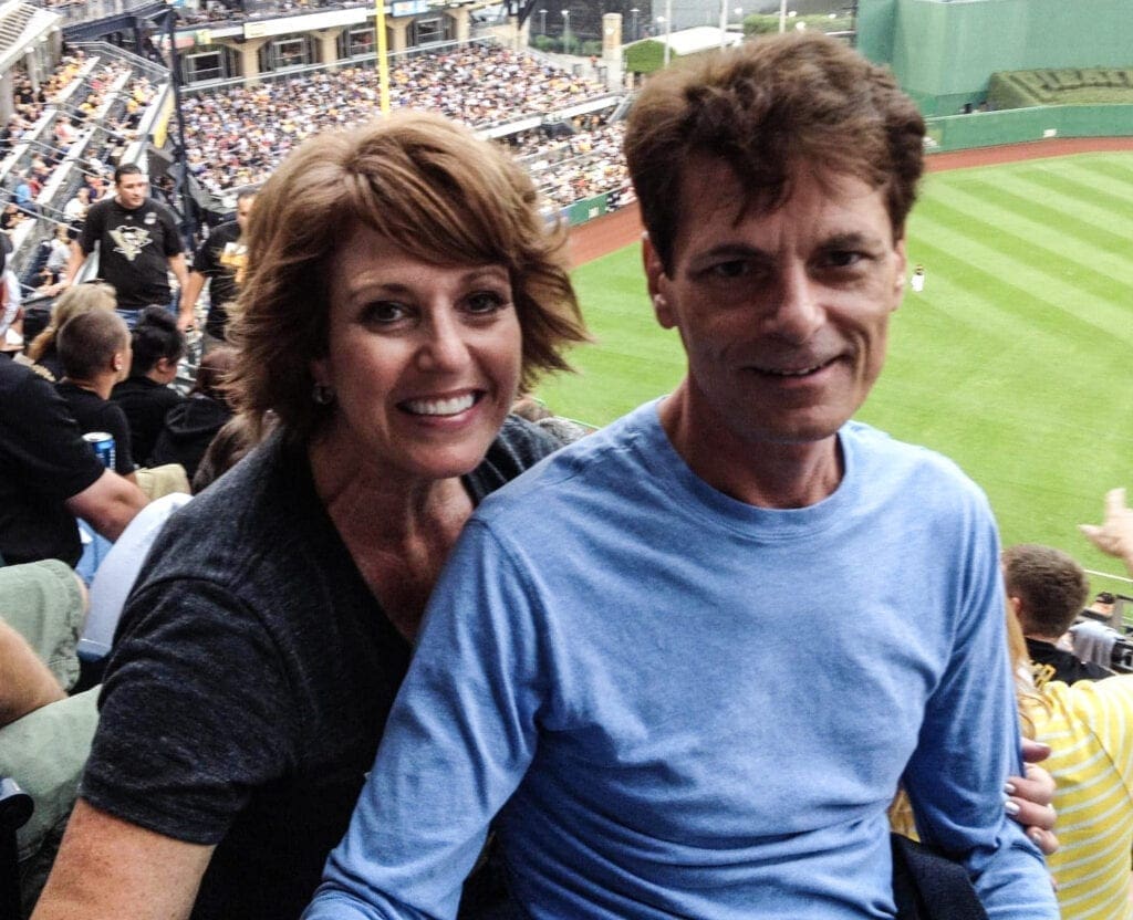 A man and a woman at a ball game.