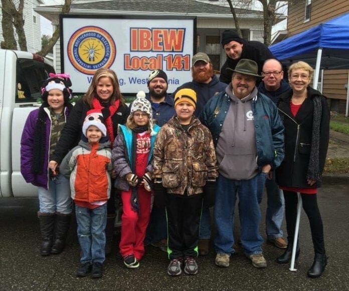 A group of people near a pick-up truck.