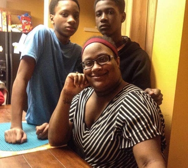 A black woman with her two sons.