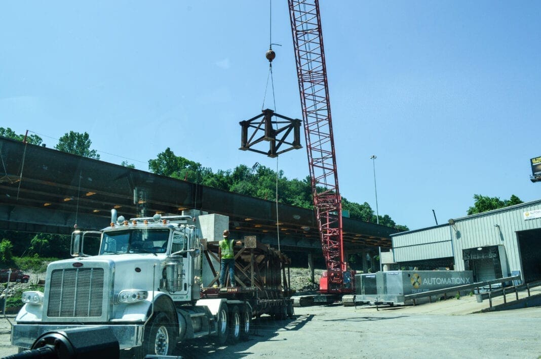 A crane lifting a bridge part.