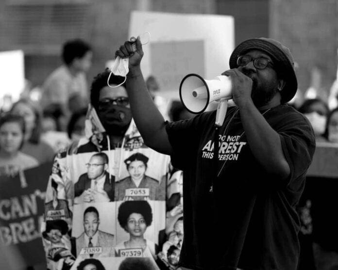 A black man with a bullhorn.