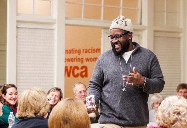 A black man in the middle of a crowd.