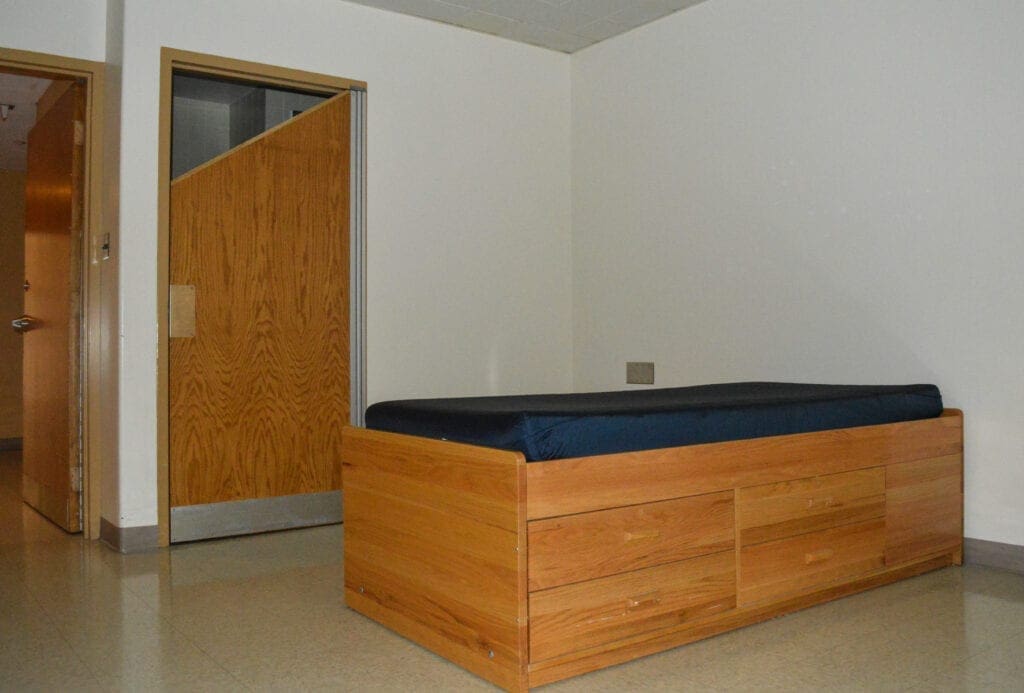 A twin bed with a wood frame.