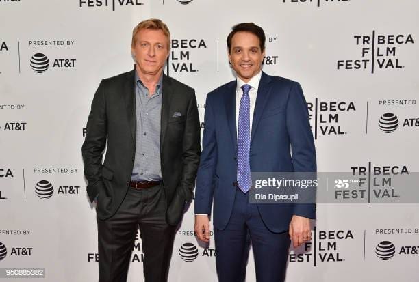 Both men are smiling.