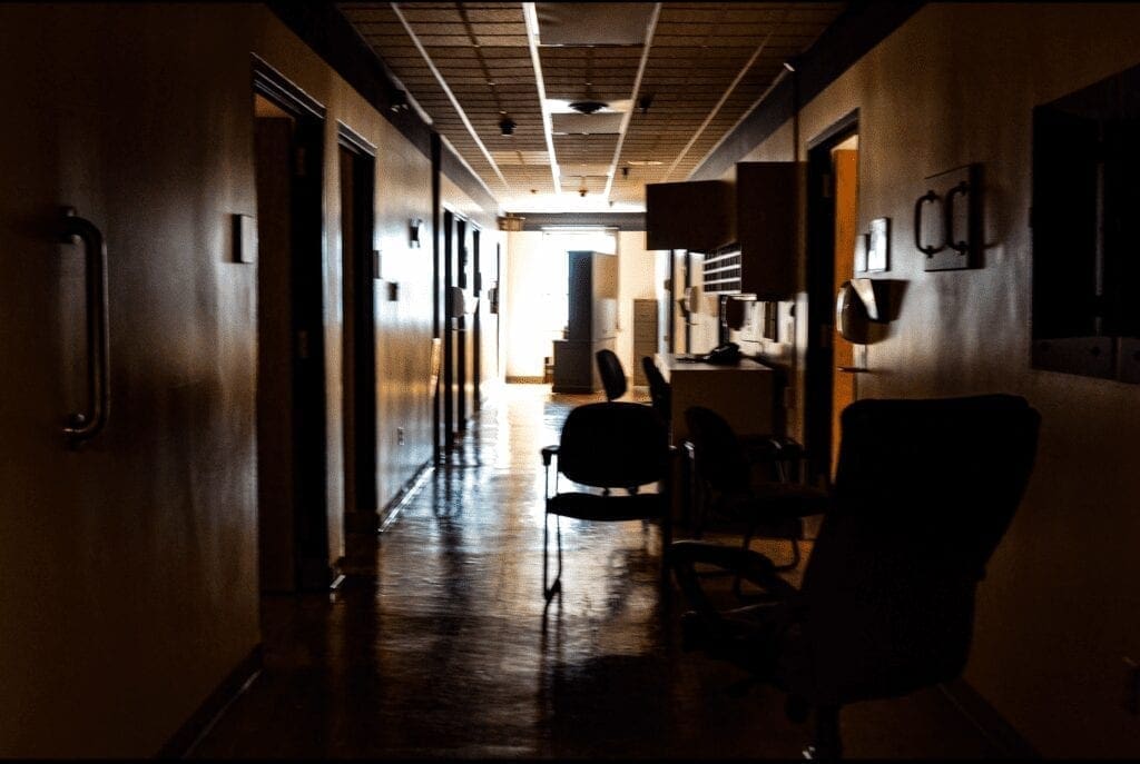 A dark hallway in a former hospital.