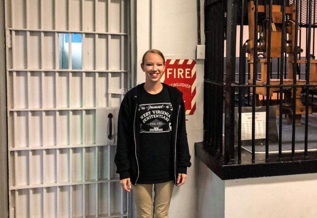 A young lady inside a prison museum.