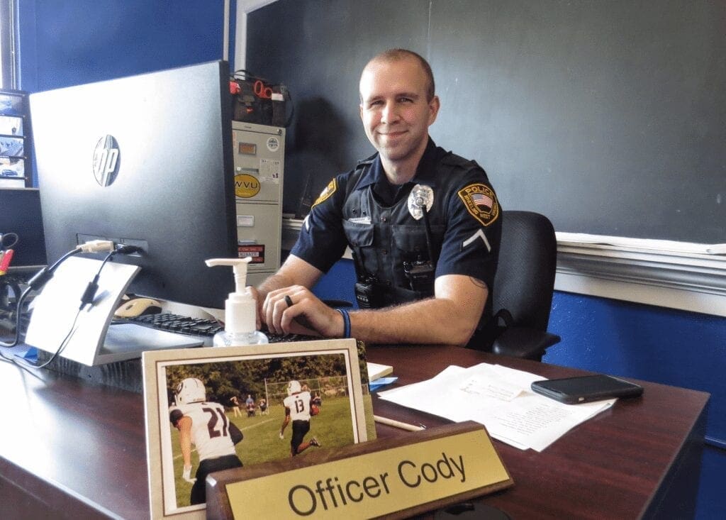 A police officer at a desk.