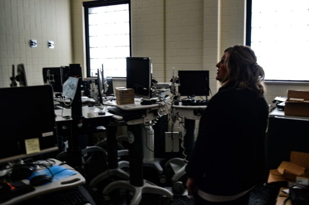 A woman standing with a lot of hospital equipment.