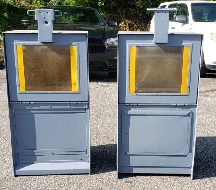 A photo of two newspaper boxes.