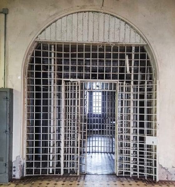 An elaborate door inside an old prison.