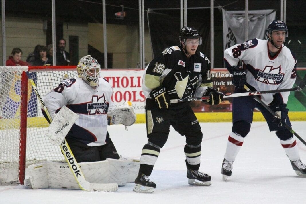 A hockey player in front of the net.