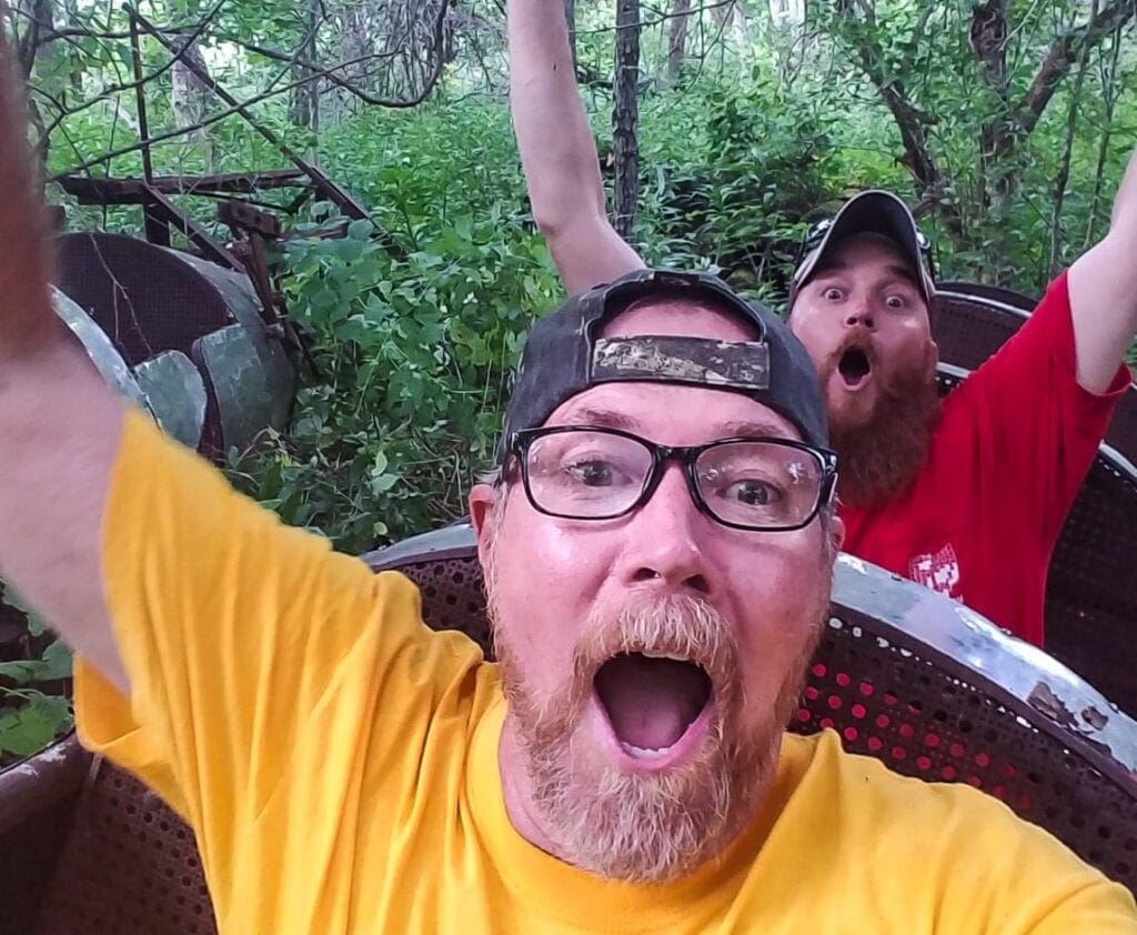 Two men in an abandoned park ride.