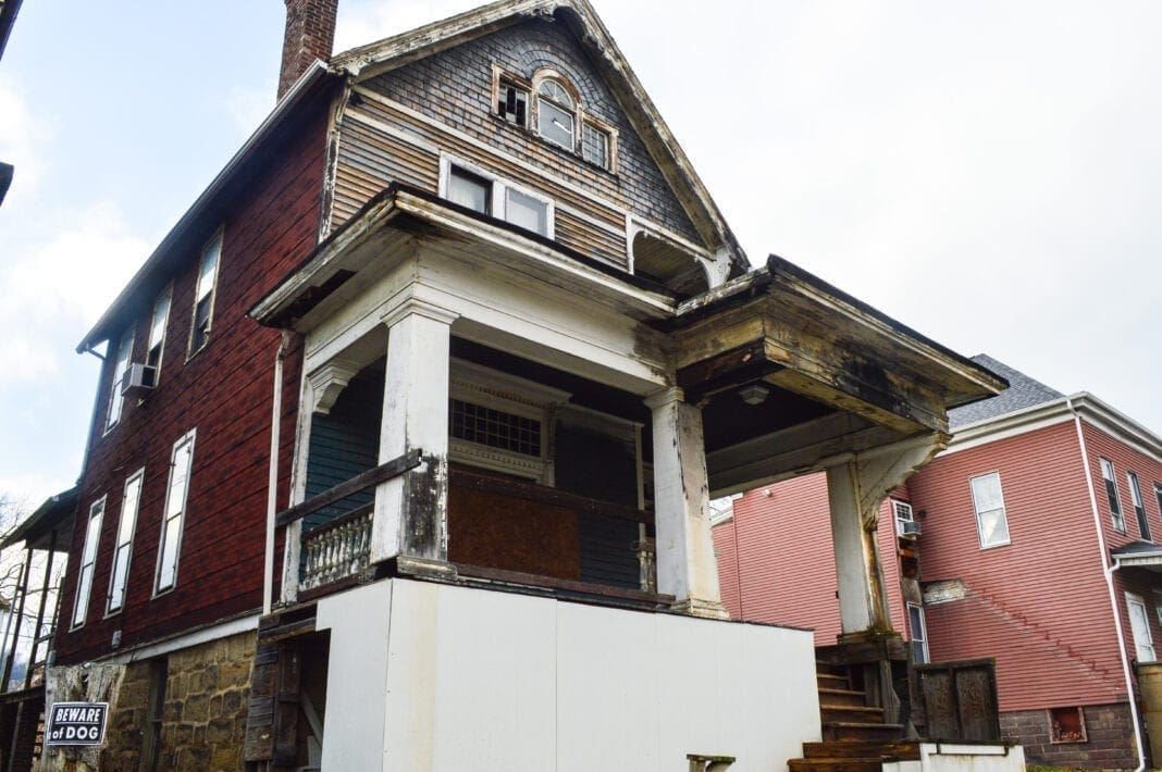 A house with boards covering windows.