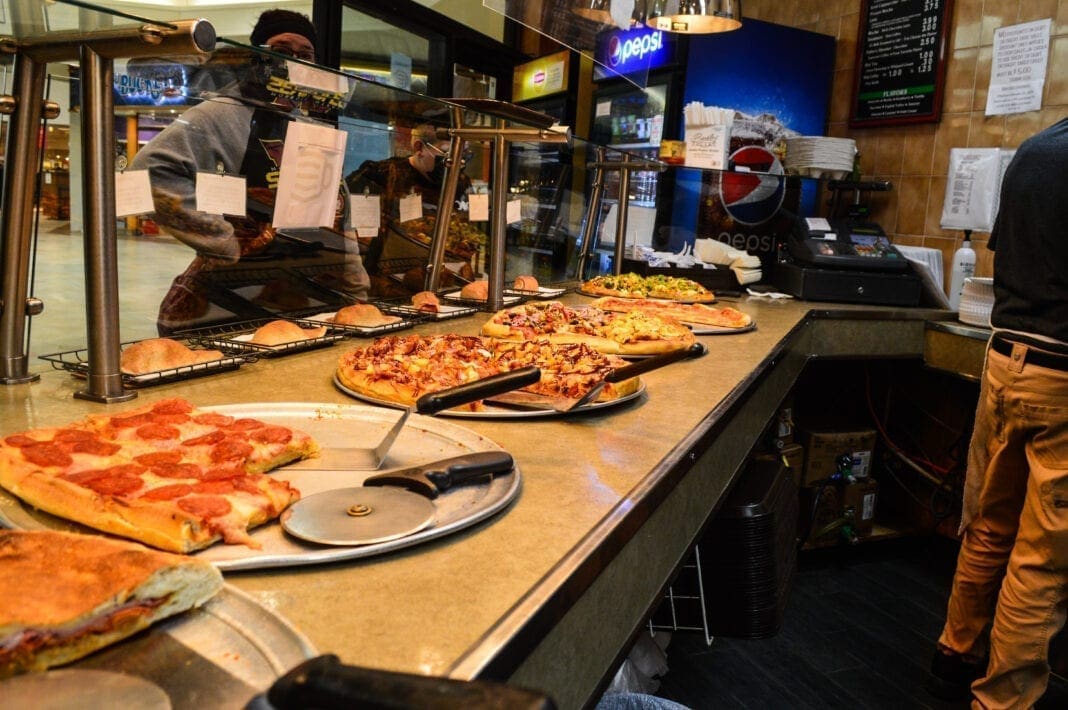 A counter at a pizza shop.