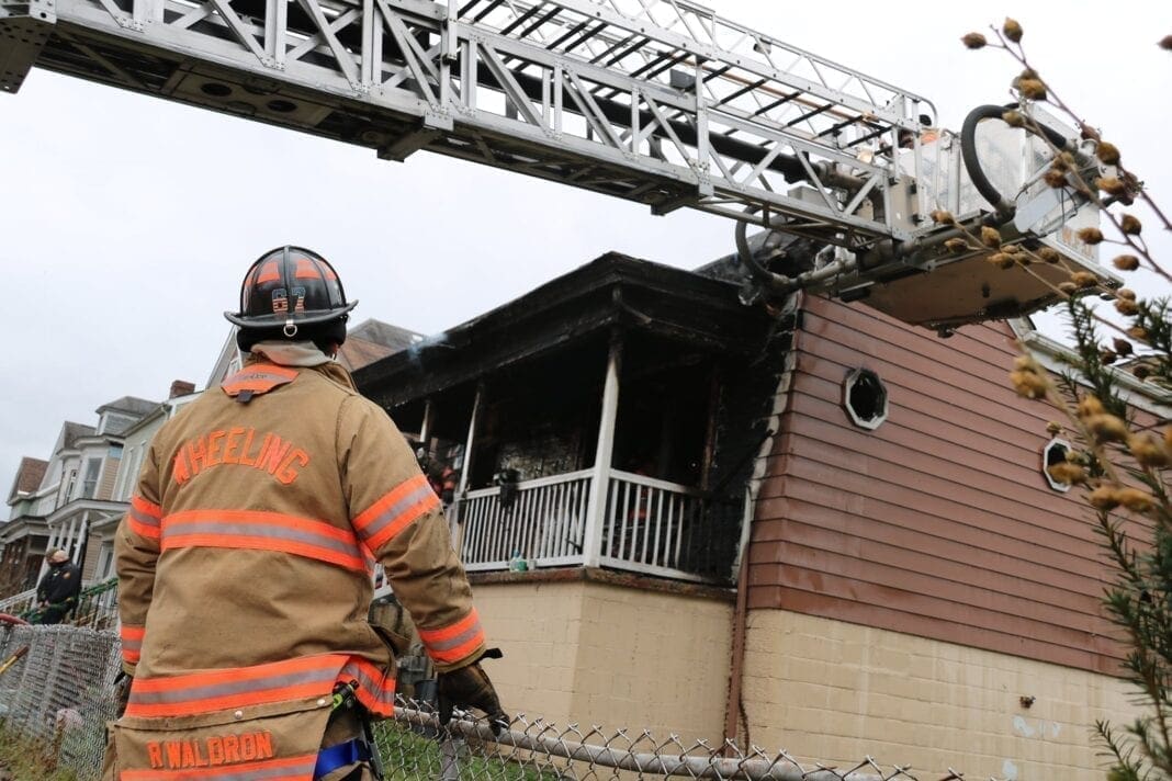 A house fire with firefighters.