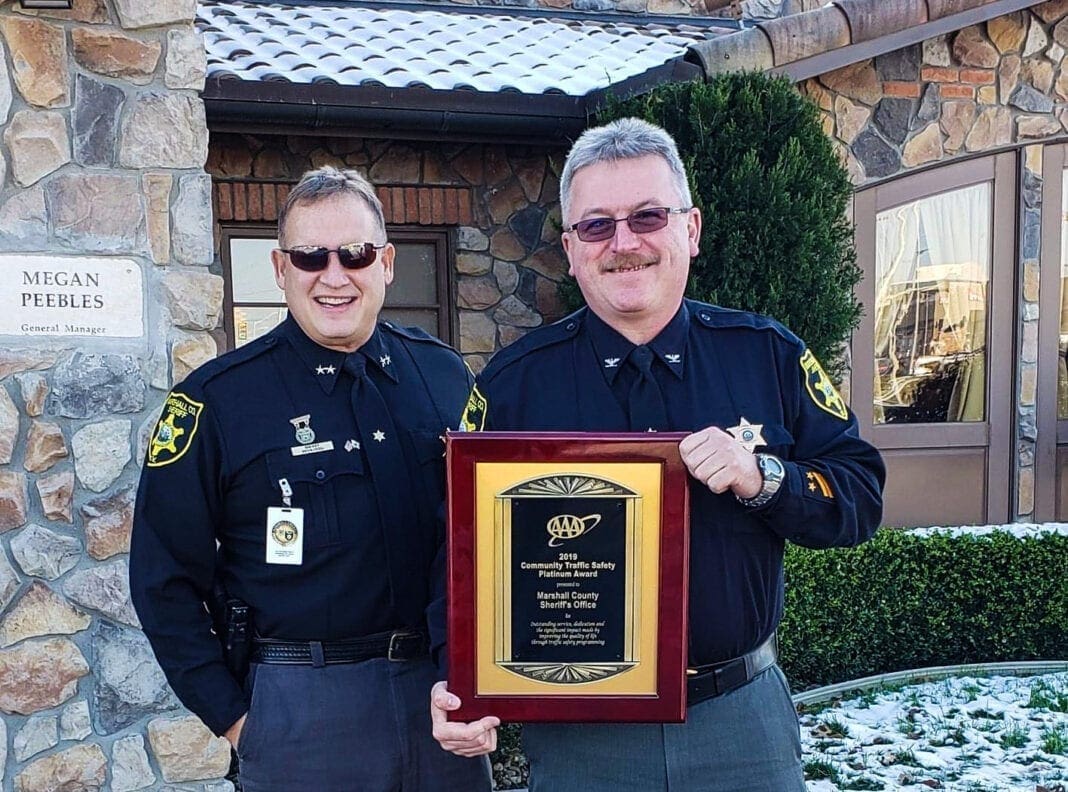 Two men in law enforcement uniforms.