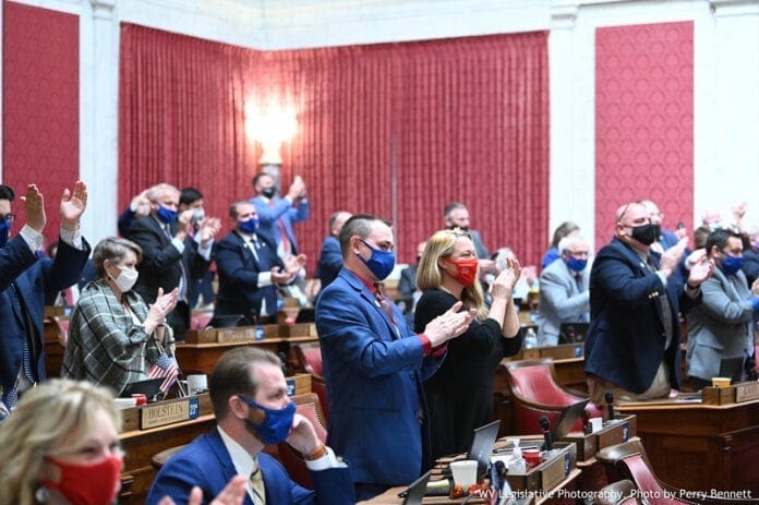 Lawmakers applauding.