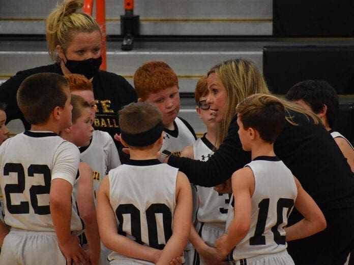 Stacy Bordas talks to her son and his teammates during a timeout