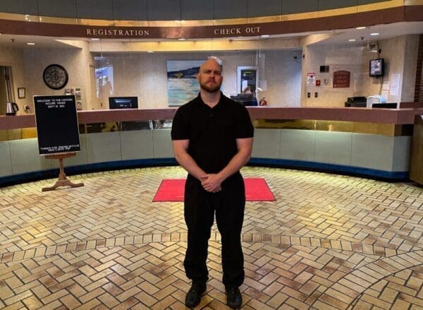A man standing in a hotel lobby.