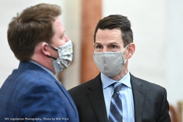 Two men wearing masks.