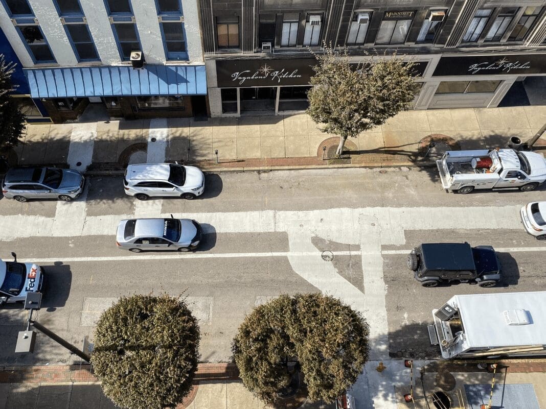 A bird's eye view of a street in a downtown.