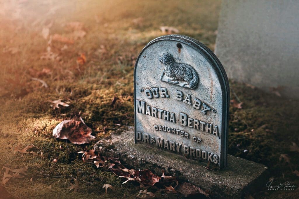 A tombstone with a baby on it.