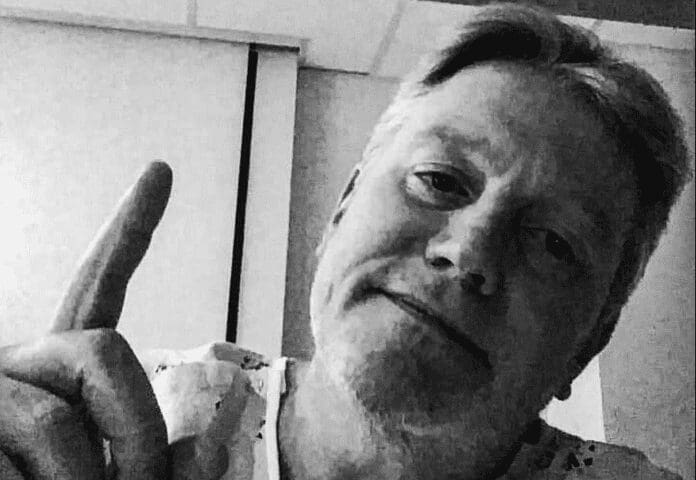 A man with his finger in the air.