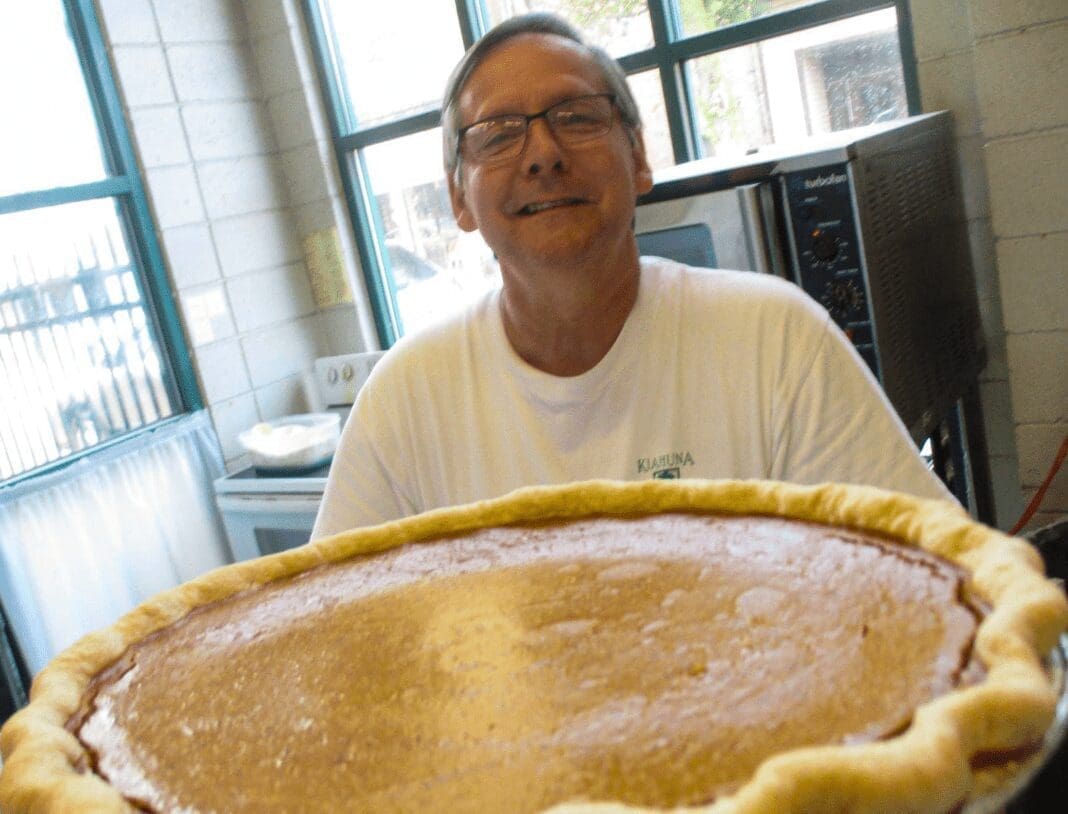 A man holding a pie.