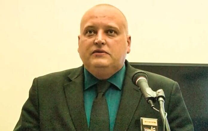 E0BE322B-8FD7-469F-A584-2D7D556D5F3A A man with a bald head.