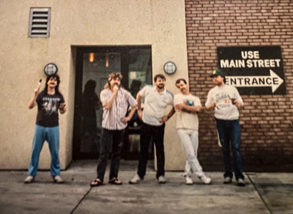 A few men in front of building.